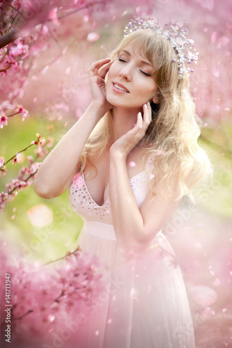 Beautiful girl in a spring blooming garden