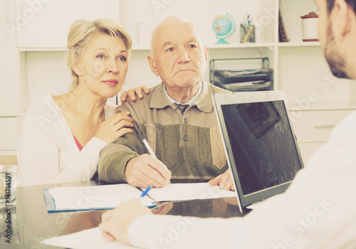 Old man and woman in social department photo