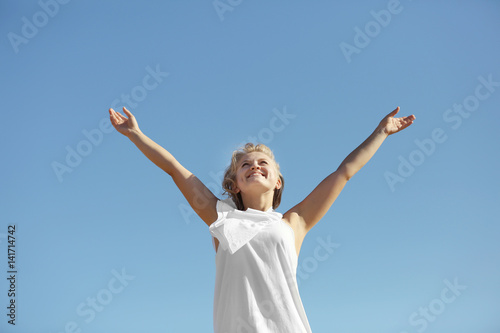 Happy woman on blue sky background