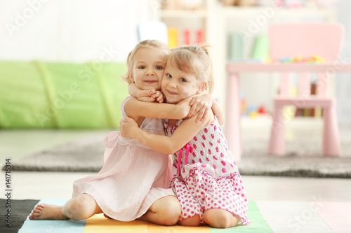 Adorable little girls in be...