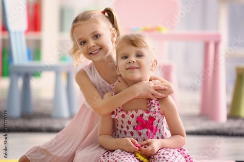 Adorable little girls in be...