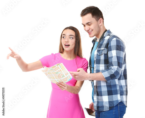 Young couple with guide map on white background