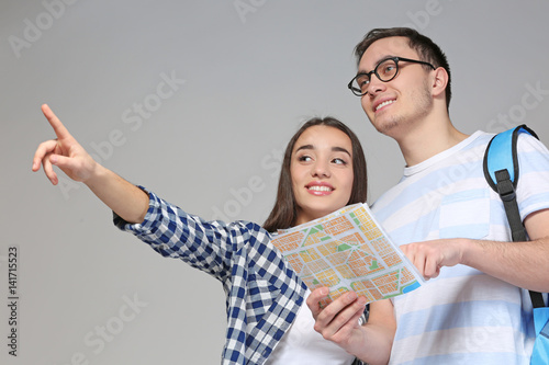 Young couple with guide map...