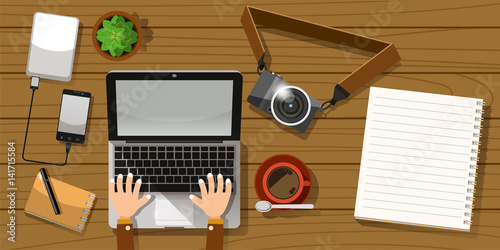 Working alone on a wooden table. Top view flat concept.