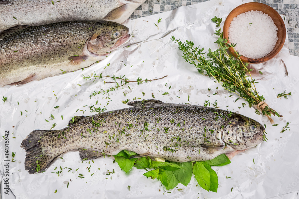 Preparing whole trout for grill in the garden Preparing whole trout for grill in the garden