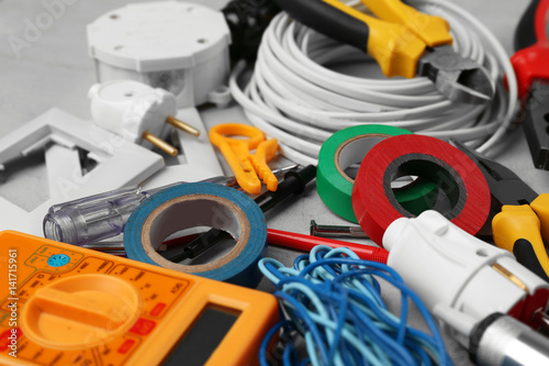 Electrician tools on grey background, closeup