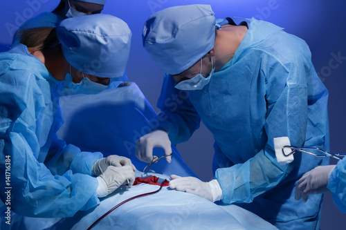 Surgeons operating patient ...