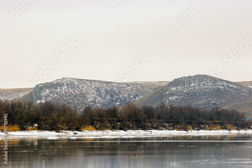 Two mountains background of the river in winter photo