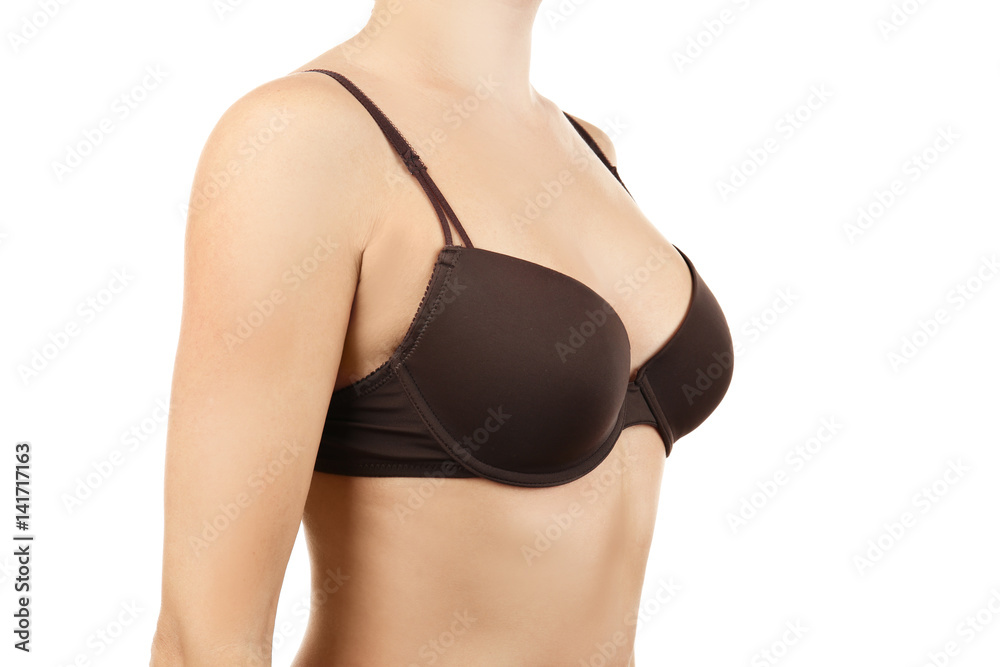 Young woman in black bra on white background
