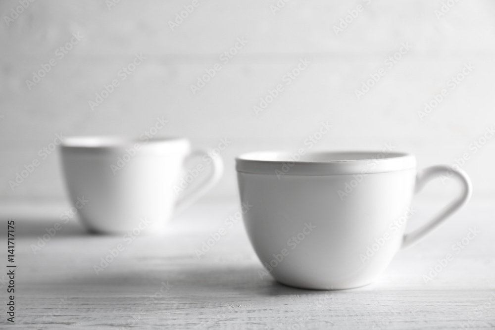 Blank ceramic cup on wooden table Blank ceramic cup on wooden table