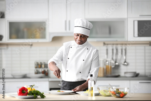 Mature Indian chef cooking ...