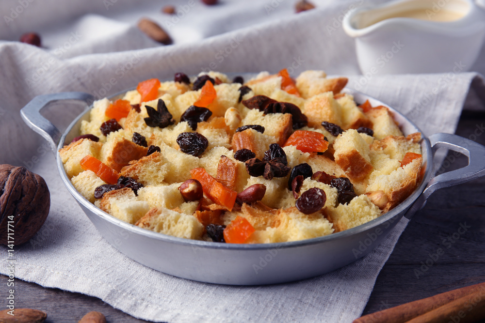 Tasty bread pudding with dried fruits on wooden table Tasty bread pudding with dried fruits on wooden table