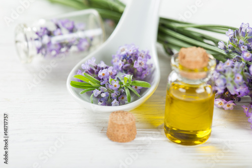 Wellness treatments with lavender flowers on wooden table.