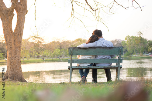 couple sitting on bench in the garden