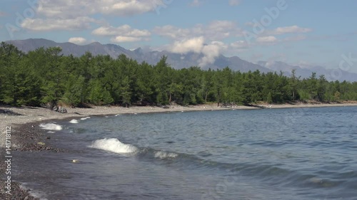 Rocky shore of Lake Baikal covered with beautiful larch. The Baikal-Lensky Reserve