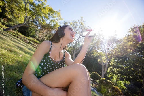 Happy woman listening to music on mobile phone © WavebreakMediaMicro