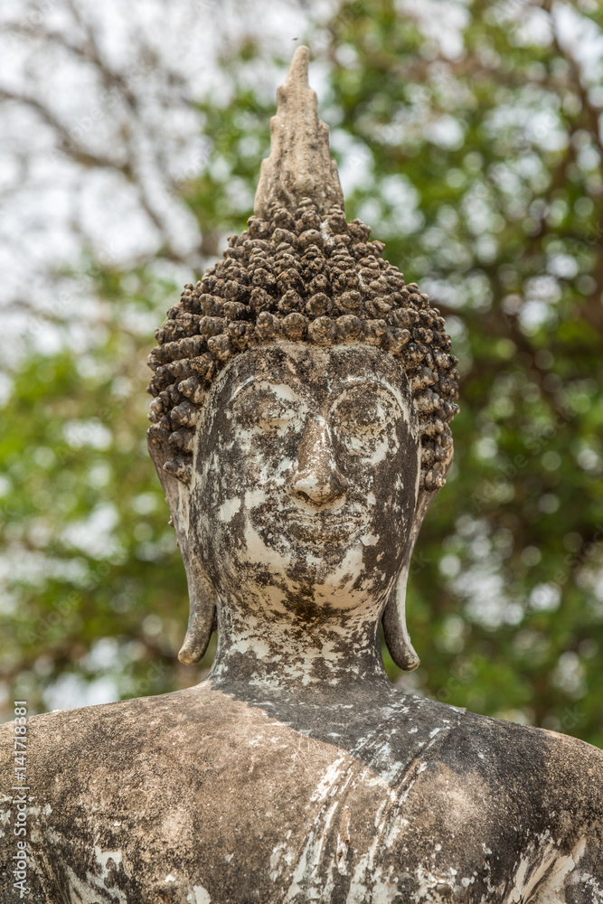 Old concrete Buddha image in Sukhothai historical park, travel destination of Thailand