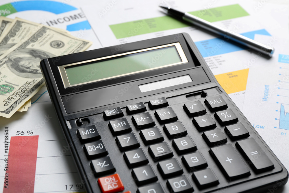 Tax concept. Calculator and money on table Tax concept. Calculator and money on table
