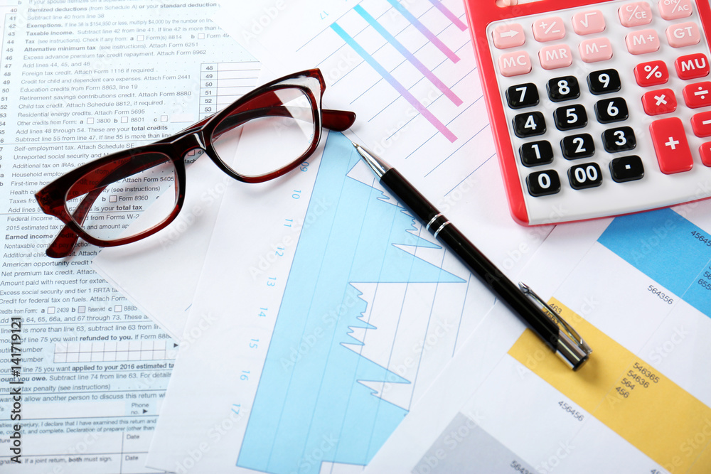 Calculator with glasses and pen on documents. Tax concept Calculator with glasses and pen on documents. Tax concept