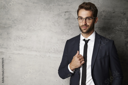 Businessman smiling in spectacles, portrait