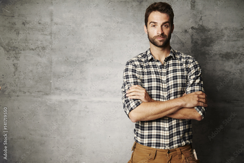 Portrait of man in checked shirt, studio Portrait of man in checked shirt, studio