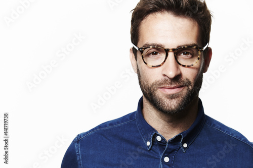 Handsome in glasses looking at camera