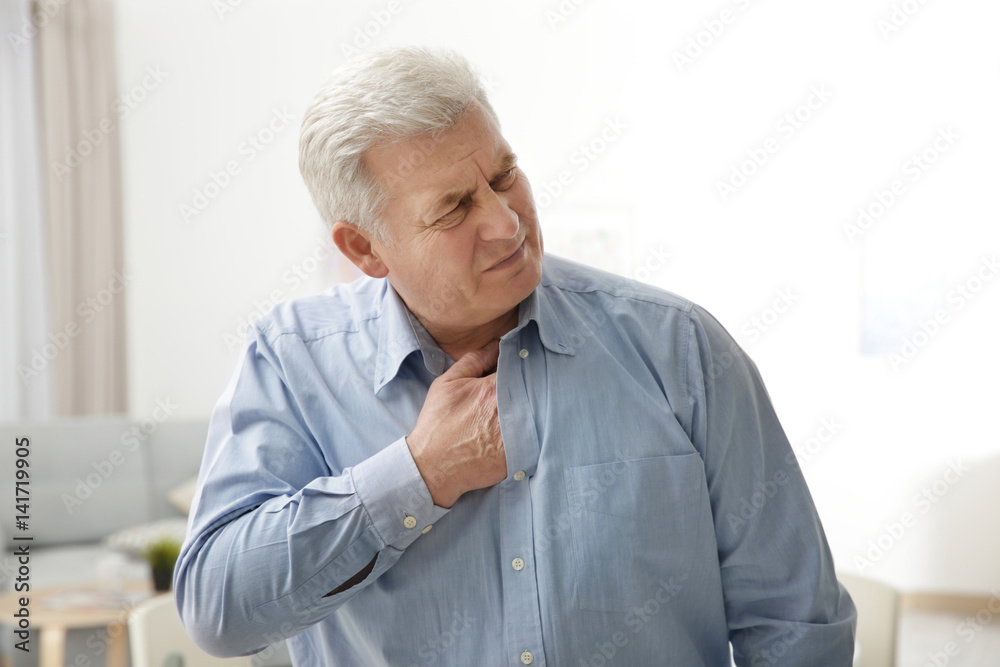 Man with chest pain suffering from heart attack in office Man with chest pain suffering from heart attack in office