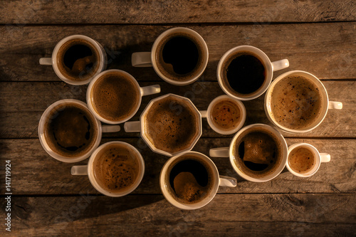 Lots of coffee cups on wooden background