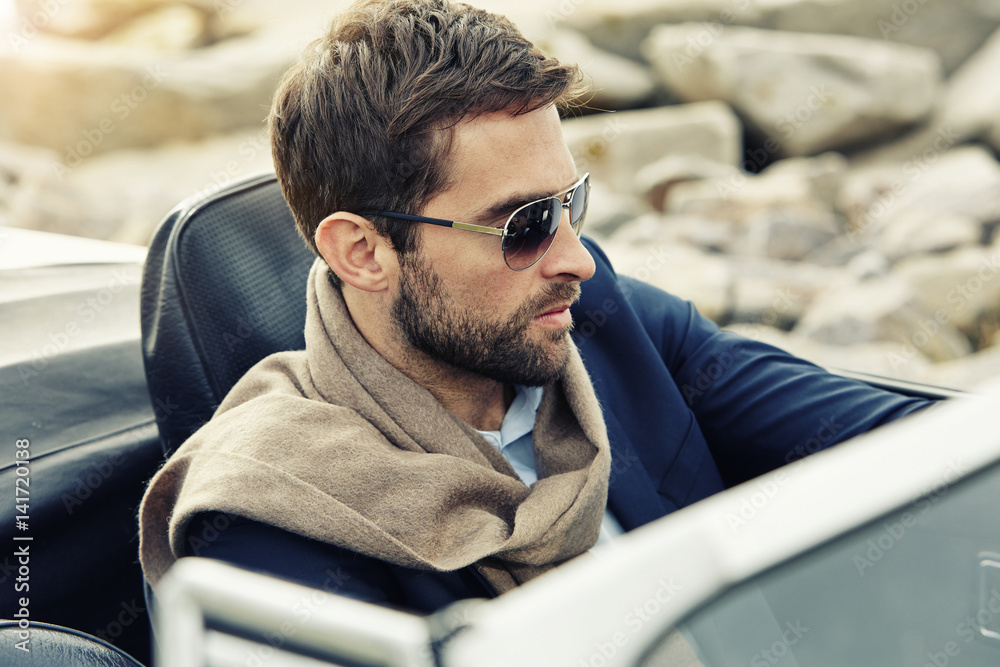 Fotografie Serious man driving car, close up