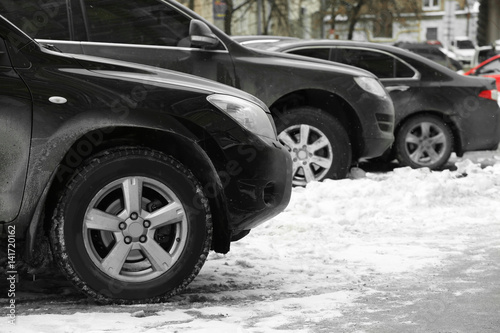 Parked cars after snowfall in winter time