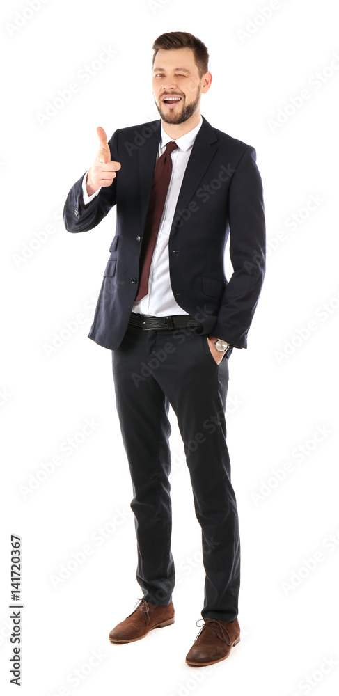 Handsome businessman in elegant suit winking and pointing on white background Handsome businessman in elegant suit winking and pointing on white background