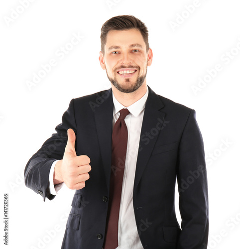 Handsome man in elegant suit showing thumb up on white background