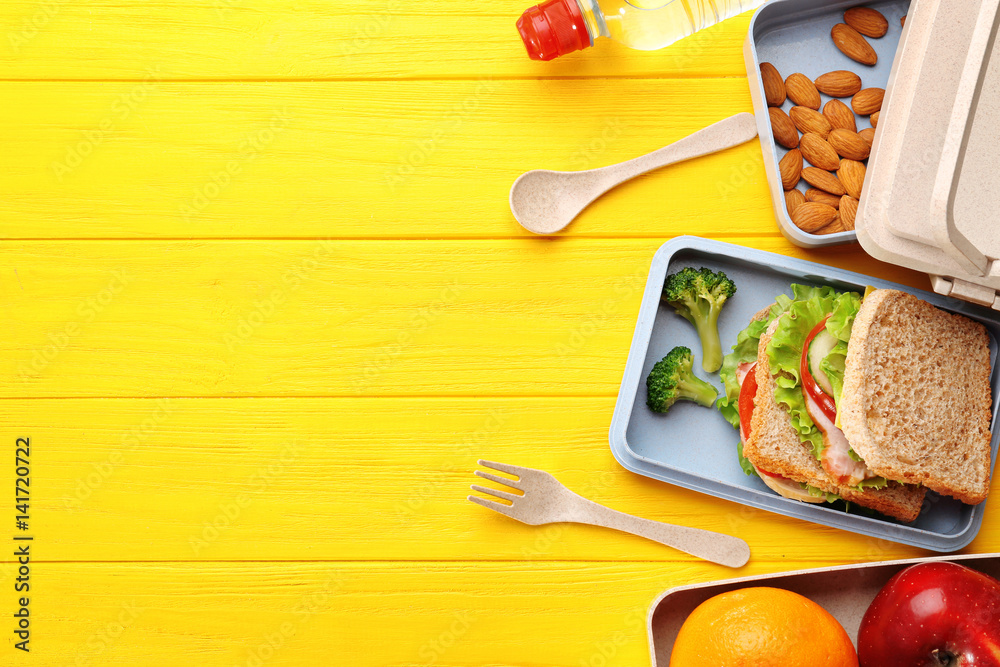 Healthy food in lunch boxes on yellow wooden background Stock Photo | Adobe  Stock