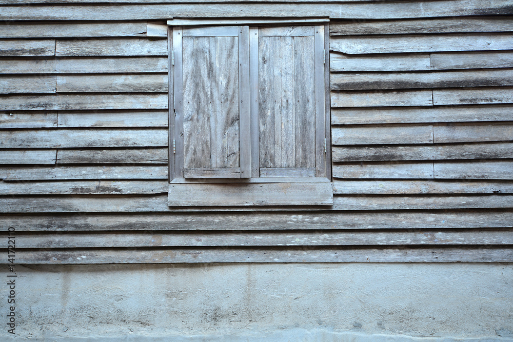 Old wooden window on a wooden wall texture background Old wooden window on a wooden wall texture background