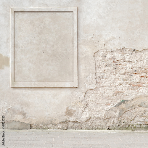 abandoned grunge cracked brick stucco wall with a stucco frame