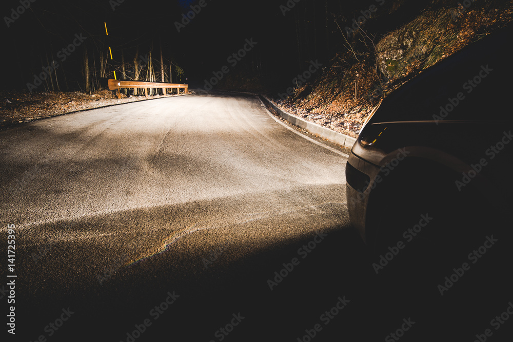 the headlights of a car on mountain road in the night - concept driving safety - obrazy, fototapety, plakaty 