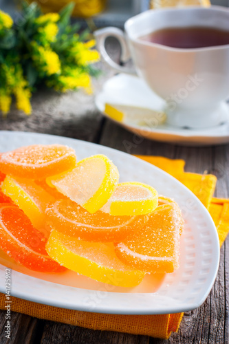A beautiful sweet marmalade, like lemon and orange slices, covered with sugar. Selective focus photo