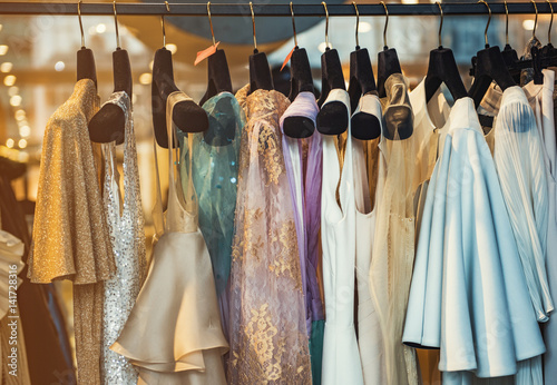Colorful clorhes on racks in a fashion boutique photo