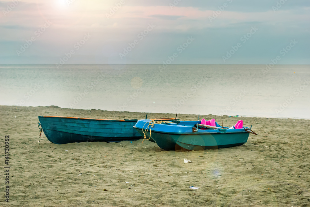 Beautiful empty sandy beach, with boat and palim tree, Greece - Paralia