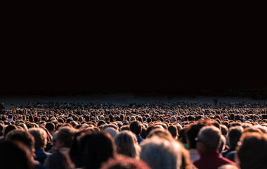 Panoramic photo of large crowd of people. Slow shutter speed motion blur.