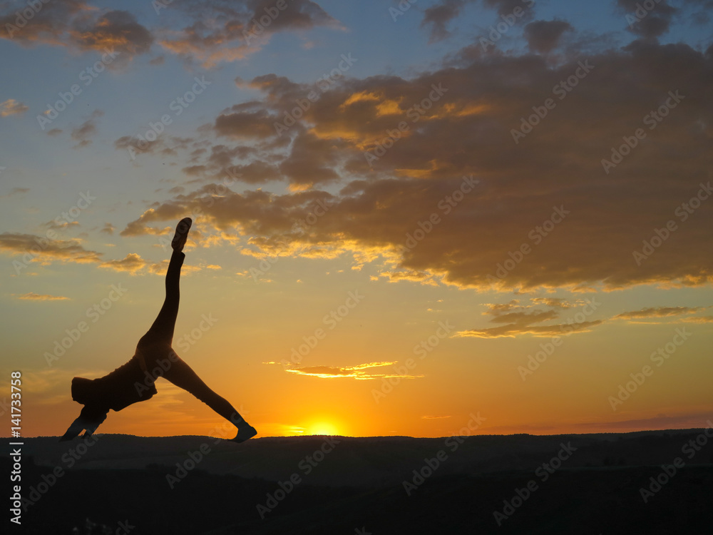 Girl practicing yoga on a background of mountains and sunset Girl practicing yoga on a background of mountains and sunset