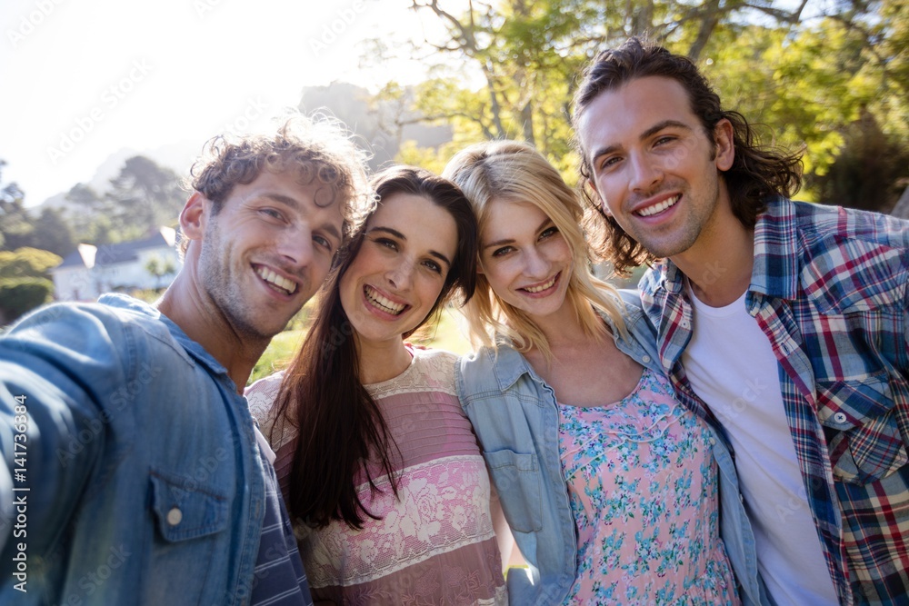 Friends standing together in park