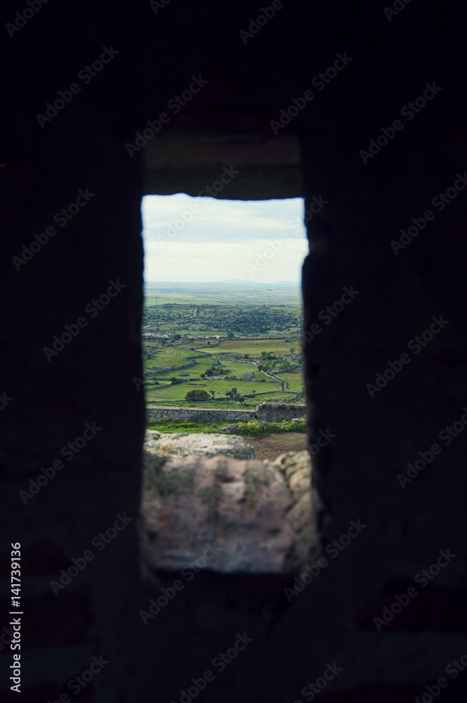 A landscape through the window of the castle