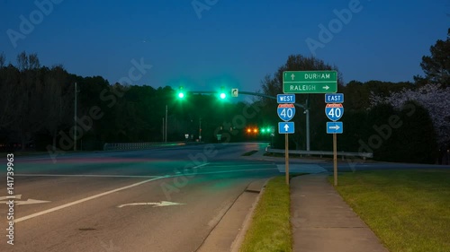 Raleigh Durham NC Interstate 40 Traffic Timelapse at Exit Interchange with Fast Moving Vehicles Passing East West Roadside Direction Signage 