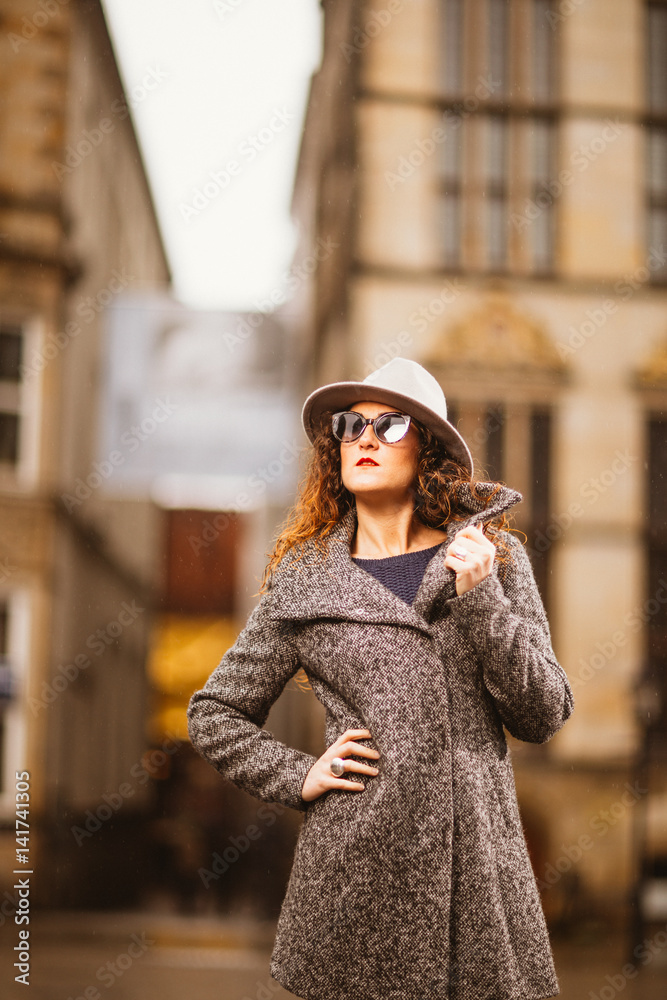 Beautiful Girl in the city centre with hat and sunglasses Beautiful Girl in the city centre with hat and sunglasses