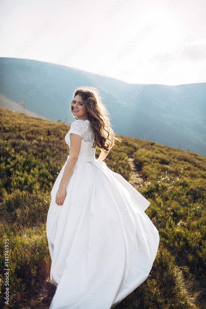 Cheerful bride runs over green autumn hill Cheerful bride runs over green autumn hill