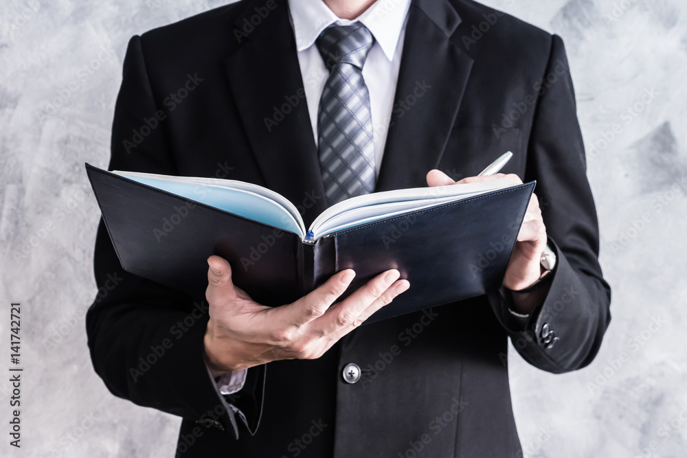 Close up of businessman checking documents on grunge background. Close up of businessman checking documents on grunge background.