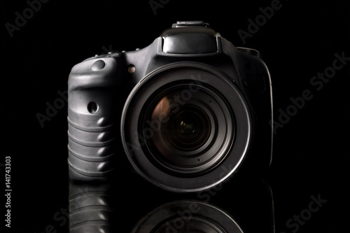 Digital camera on black background.