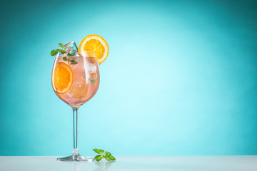 The rose exotic cocktail and fruit on blue