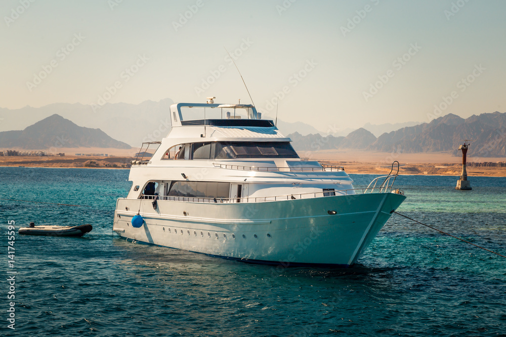 Fototapeta premium Yacht in the sea around the island. Sailboat in red sea. Yachting. Sailing. Travel Concept. Summertime Vacation